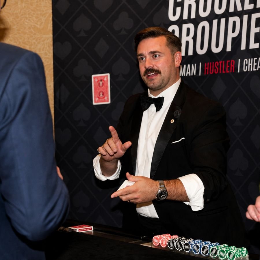 Conman magician entertaining guests at a Belgravia function