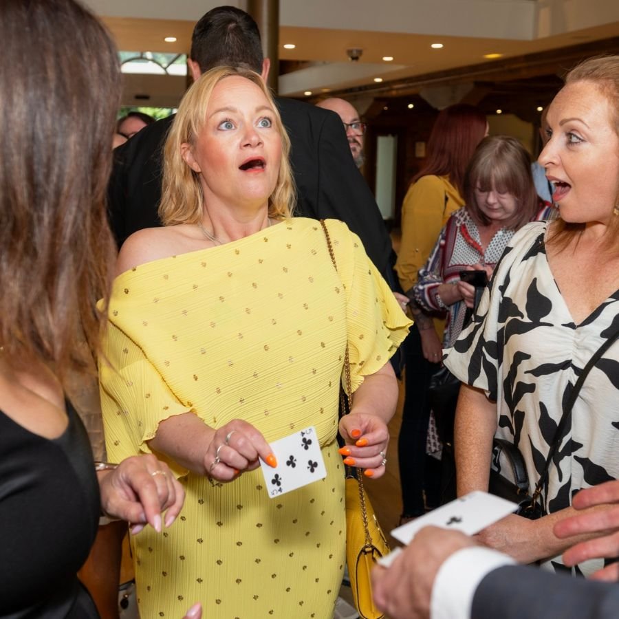 Shocked guest reacting to a close-up magician in Kensington