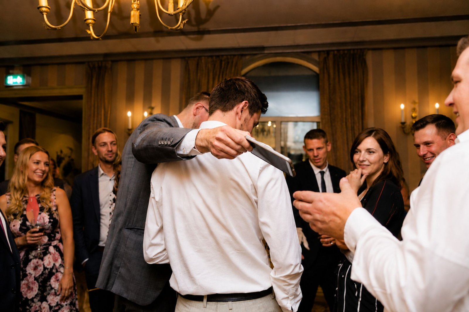 Pickpocket magician returning a watch to a guest at a London corporate event